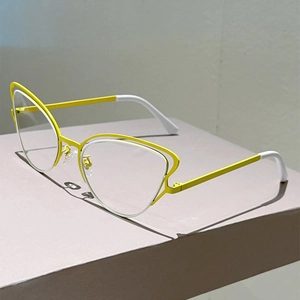 Detail view of cat eye metal frame glasses in bright yellow with double line structure