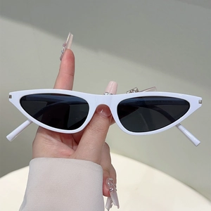 Detail view of the white narrow cat eye sunglasses frame and dark polarized lenses
