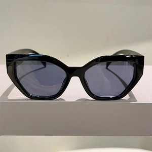 Chic geometric cat-eye sunglasses with thick black frames and translucent blue lenses