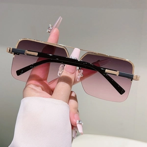 Macro shot of stylish square sunglasses with gold metal double bridge and gradient lenses