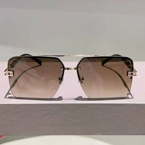 Detail of gradient brown lenses and gold double bridge on square rimless sunglasses