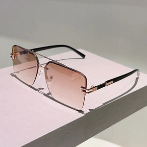 Close-up of semi-rimless square sunglasses with brown gradient lenses and rose gold double bridge