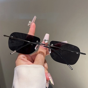 Detail of rimless polarized sunglasses with black lenses and slim silver metal temples
