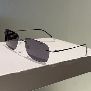 Detail of rimless rectangular polarized sunglasses with slim dark grey metal temples