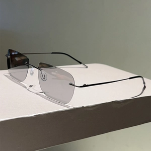 Detail view of rimless rectangular polarized sunglasses with slim metal temples and silicone pads