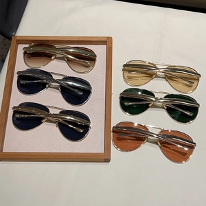 Detail of aviator sunglasses showing multi-color lenses and double bridge metal frame
