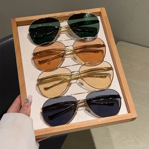 Detailed view of four pairs of metal aviator sunglasses featuring various lens colors