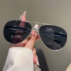 Close-up of classic silver metal aviator sunglasses with a stylish double bridge design