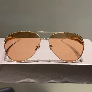 Classic aviator sunglasses with gold metal double bridge frames and orange lenses