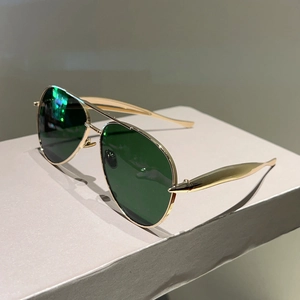 Close-up of classic aviator sunglasses with gold metal frame and dark lenses