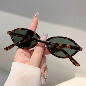 Détail de lunettes de soleil ovales vintage en écaille avec des verres foncés