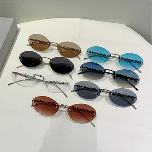 Detail of seven colored rimless oval sunglasses featuring pearl beaded bridge accents