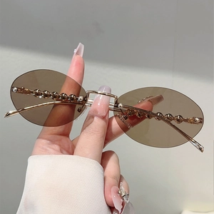 Stylish rimless oval sunglasses with brown lenses and golden pearl-embellished temples