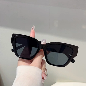 Detailed view of black square cat eye sunglasses with glossy finish resin frames