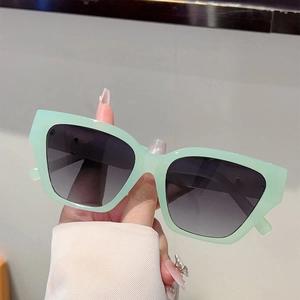 Fashionable mint green cat-eye sunglasses with gradient grey lenses and retro frame