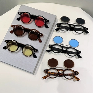 Flat lay of vintage steampunk flip-up round sunglasses in six various lens colors