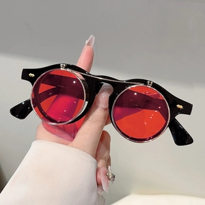 Macro view of steampunk flip-up sunglasses with red lenses and thick black frames