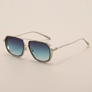Detail of square gold metal sunglasses with gradient blue lenses and double bridge design