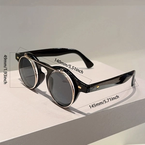 Detail view of vintage flip-up sunglasses with metal hinges and rivet accents