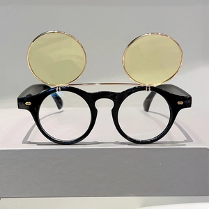 Detail view of the flip-up double lens mechanism on these punk style round sunglasses