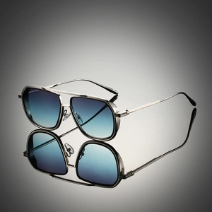 Macro detail of silver metal square frames with vertical stripe engraving and blue lenses