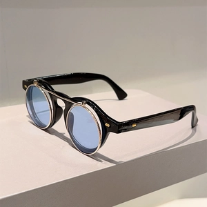 Detail of vintage flip-up sunglasses with blue round lenses and punk metal rivets
