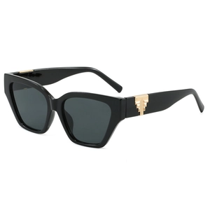 Fashionable oversized cat-eye sunglasses with thick black frames and gold geometric accents