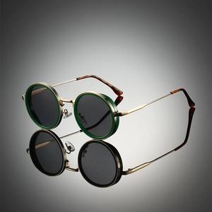Detailed close-up of retro round metal sunglasses with green rims and grey lenses
