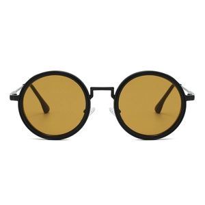 Close-up of retro round black metal frame sunglasses with bright amber yellow lenses