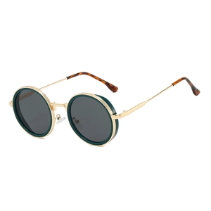 Detail view of round steampunk sunglasses with golden metal frame and green rims