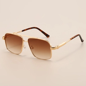 Detail of gold metal double bridge sunglasses with brown gradient lenses and tortoise tips