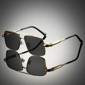 Detail of classic gold metal double-bridge aviator sunglasses with dark polarized lenses