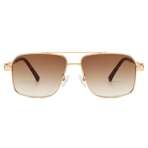 Close-up of golden double-bridge aviator sunglasses with brown gradient lenses