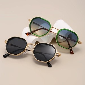 Detailed view of geometric hexagonal steampunk sunglasses with gold metal frame accents