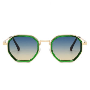 Close-up of steampunk gold metal frame sunglasses with green octagonal rims and gradient lenses