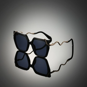 Vintage oversized sunglasses with snake-patterned metal temples and black frame