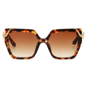 Detail of vintage tortoise shell sunglasses featuring intricate gold snake-shaped metal ornaments