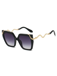 Detailed close-up of golden snake-shaped metal temple on vintage oversized sunglasses