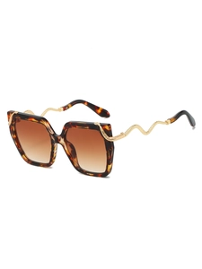 Macro detail of golden snake-shaped metal temples on tortoise shell square sunglasses