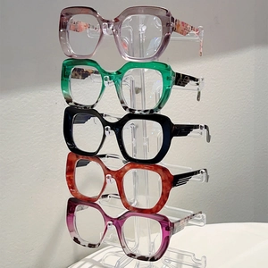 Detail of five assorted cat-eye frame colors with unique gold wing metal accents