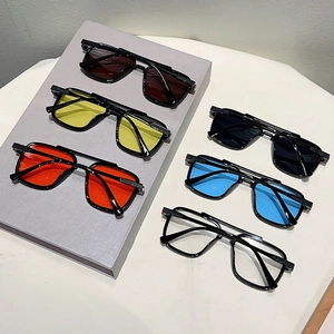 Collection of oversized double-bridge sunglasses in diverse lens colors on white background