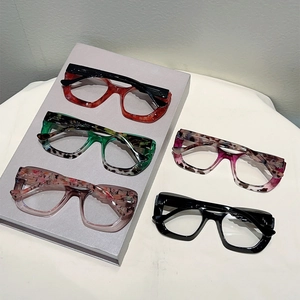 Detailed display of chunky acetate cat-eye glasses frames in multiple leopard patterns