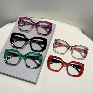 Detailed display of chunky leopard print cat-eye glasses frames in multiple color variations