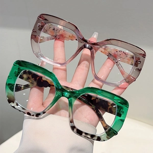 Detail view of leopard print cat eye frames in translucent green and gradient purple pink