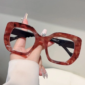Cat eye glasses with red-brown marble frames and black temples, blue light blocking lens