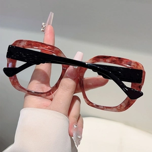 Close-up of leopard pattern oversized cat-eye glasses frame with glossy black temples