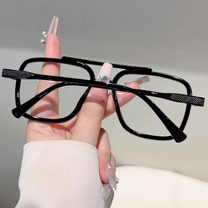 Detail of oversized double bridge sunglasses showing intricate quilted texture on the temples