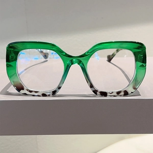 Detail view of cat eye glasses with green and leopard print splicing frames
