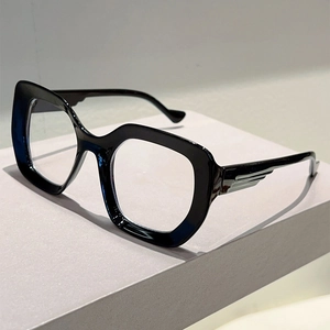 Detail of cat-eye frames featuring silver feather-shaped metal accents on temple hinges