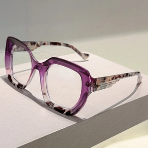 Detailed side view of purple gradient frame with tortoiseshell temples and wing relief